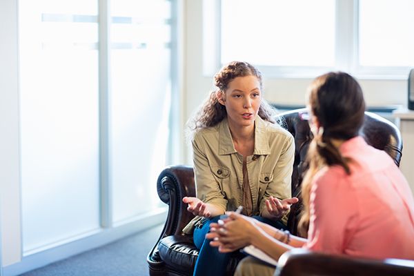 Listening, Counselling and Training Image showing a young lady discussing issues